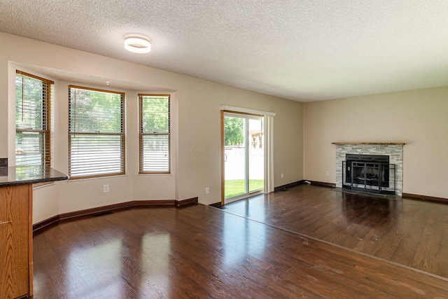 7345 Oakmeadows Dr, Columbus, OH 43085 - unfurnished living room featuring wood finished floors, a fireplace, and a textured ceiling