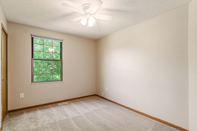 7345 Oakmeadows Dr, Columbus, OH 43085 - spare room featuring a textured ceiling, light carpet, and a ceiling fan