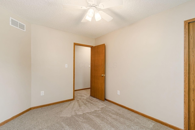 7345 Oakmeadows Dr, Columbus, OH 43085 - spare room with light carpet, a textured ceiling, and ceiling fan