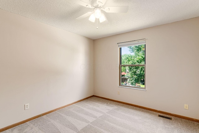 7345 Oakmeadows Dr, Columbus, OH 43085 - unfurnished room with light carpet, a ceiling fan, and a textured ceiling