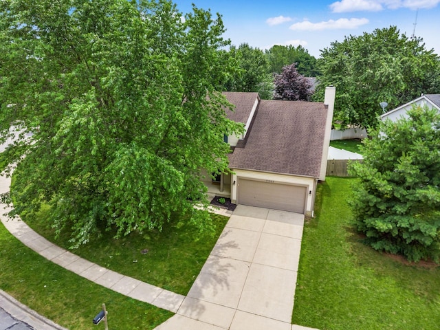 7345 Oakmeadows Dr, Columbus, OH 43085 - view of front of house with driveway, an attached garage, roof with shingles, and a chimney