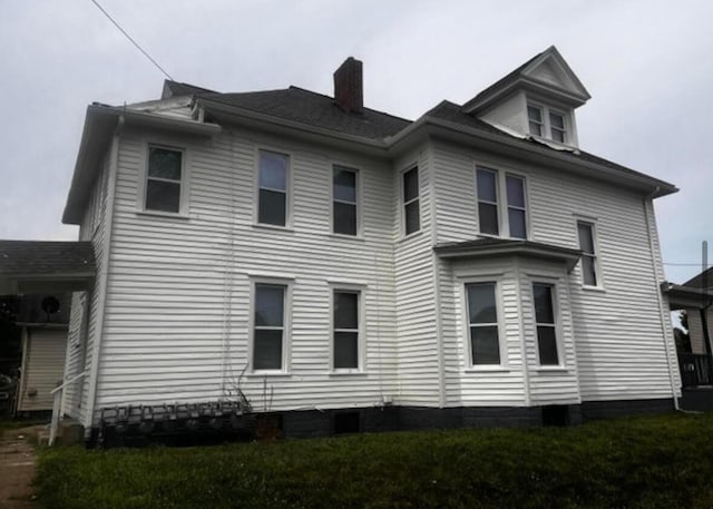 51 E N St, Newark, OH 43055 - view of property exterior with a chimney and a lawn