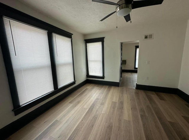 51 E N St, Newark, OH 43055 - spare room featuring ceiling fan, wood finished floors, and a textured ceiling