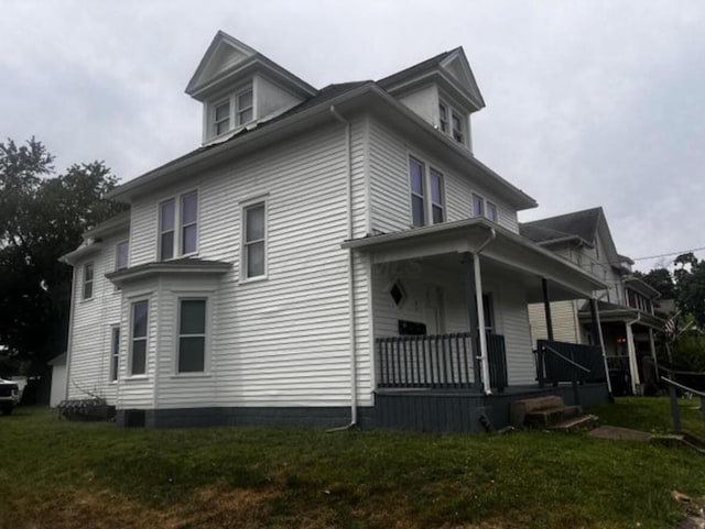 51 E N St, Newark, OH 43055 - view of side of home with covered porch and a yard