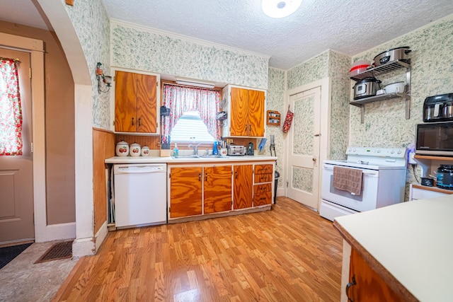 559 Pearl St, Marion, OH 43302 - kitchen featuring white appliances, wallpapered walls, brown cabinets, light wood finished floors, and light countertops