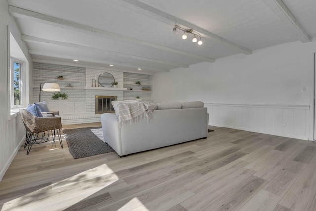 1080 Coonpath Rd NW, Lancaster, OH 43130 - living area featuring beamed ceiling, wood finished floors, a brick fireplace, and wainscoting