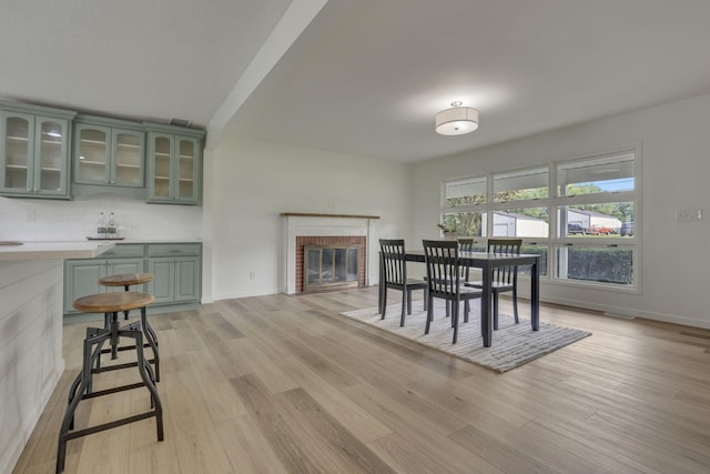 1080 Coonpath Rd NW, Lancaster, OH 43130 - dining room with light wood-type flooring and a fireplace