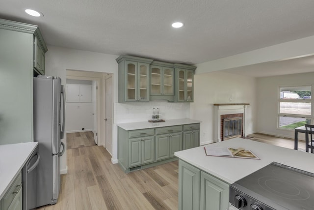 1080 Coonpath Rd NW, Lancaster, OH 43130 - kitchen with green cabinets, appliances with stainless steel finishes, light countertops, recessed lighting, and a textured ceiling