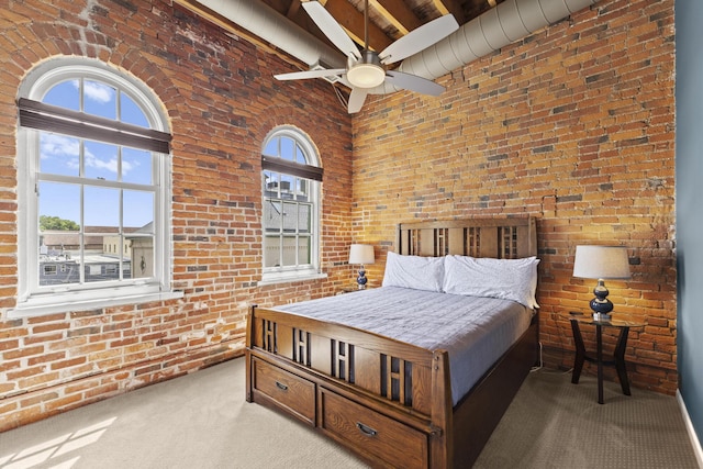 51 W Blenkner St Unit 306, Columbus, OH 43215 - carpeted bedroom featuring brick wall, a towering ceiling, ceiling fan, and beamed ceiling