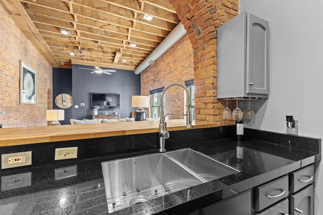 51 W Blenkner St Unit 306, Columbus, OH 43215 - kitchen with brick wall and a ceiling fan