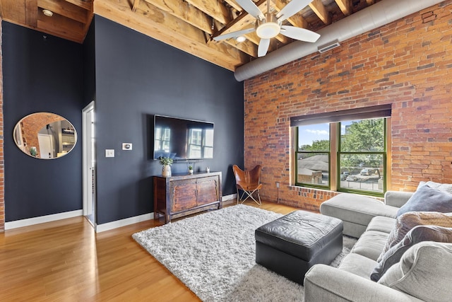 51 W Blenkner St Unit 306, Columbus, OH 43215 - living area featuring a towering ceiling, ceiling fan, plenty of natural light, beam ceiling, and wood finished floors