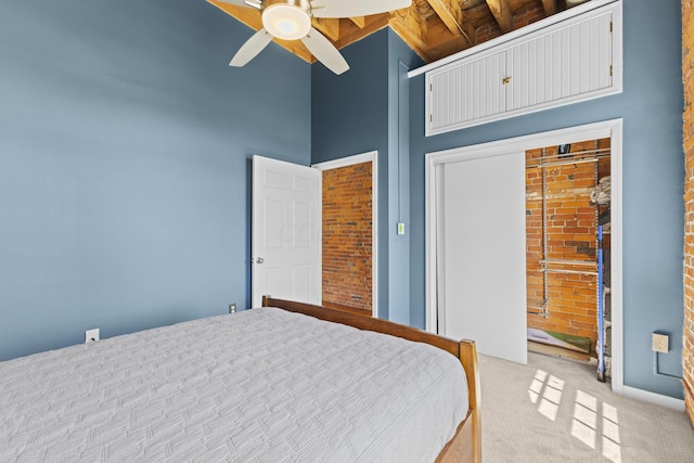 51 W Blenkner St Unit 306, Columbus, OH 43215 - bedroom featuring light colored carpet, a ceiling fan, a closet, and brick wall
