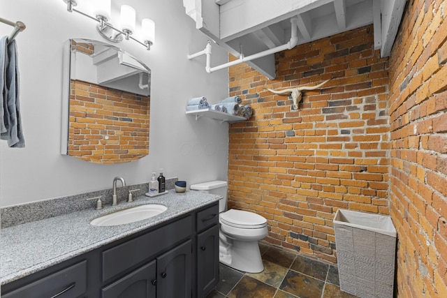 51 W Blenkner St Unit 306, Columbus, OH 43215 - bathroom featuring brick wall, stone tile flooring, and vanity