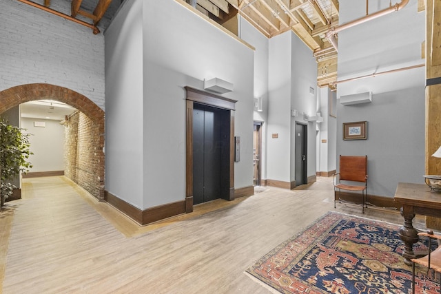 51 W Blenkner St Unit 306, Columbus, OH 43215 - common area featuring a high ceiling and brick wall