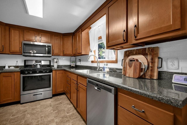4619 Spring Hill Rd, Heath, OH 43056 - kitchen featuring appliances with stainless steel finishes, brown cabinetry, backsplash, and dark stone countertops