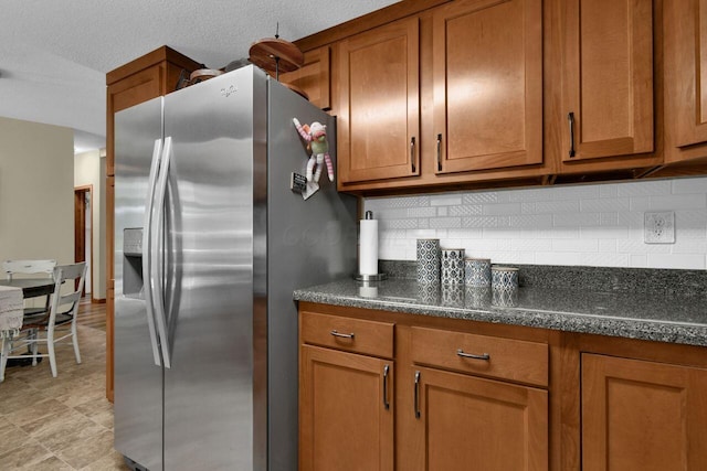 4619 Spring Hill Rd, Heath, OH 43056 - kitchen with stainless steel fridge with ice dispenser, brown cabinets, and tasteful backsplash