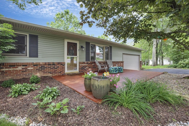 748 Forward Pass Rd SW, Pataskala, OH 43062 - view of front facade featuring an attached garage, brick siding, a wooden deck, and driveway