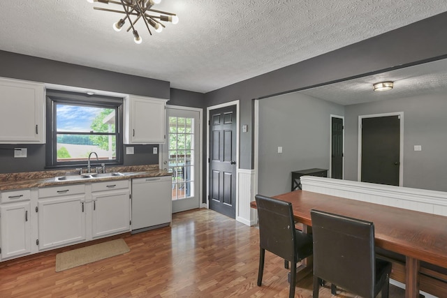 748 Forward Pass Rd SW, Pataskala, OH 43062 - kitchen featuring white dishwasher, a textured ceiling, light wood-style flooring, white cabinetry, and dark countertops