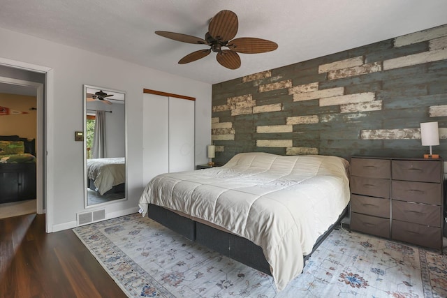 748 Forward Pass Rd SW, Pataskala, OH 43062 - bedroom with an accent wall, a closet, wood finished floors, and a ceiling fan