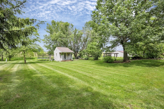 748 Forward Pass Rd SW, Pataskala, OH 43062 - view of grassy yard with a trampoline and an outdoor structure