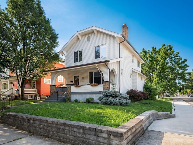 211 E Jenkins Ave, Columbus, OH 43207 - view of front of home with a porch, a chimney, and a front yard