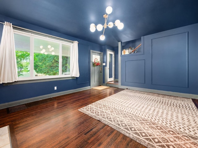 211 E Jenkins Ave, Columbus, OH 43207 - unfurnished bedroom featuring a chandelier and dark wood-style flooring