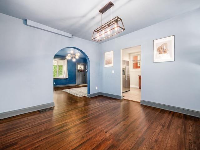 211 E Jenkins Ave, Columbus, OH 43207 - empty room with arched walkways and wood finished floors