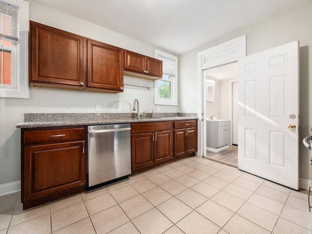 211 E Jenkins Ave, Columbus, OH 43207 - kitchen featuring stainless steel dishwasher, dark countertops, and light tile patterned floors