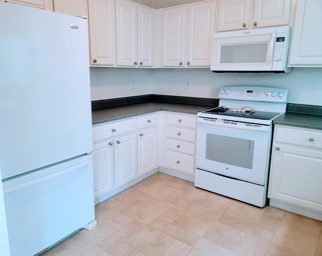 417 Hannifin Dr, Blacklick, OH 43004 - kitchen featuring white appliances, dark countertops, and white cabinetry
