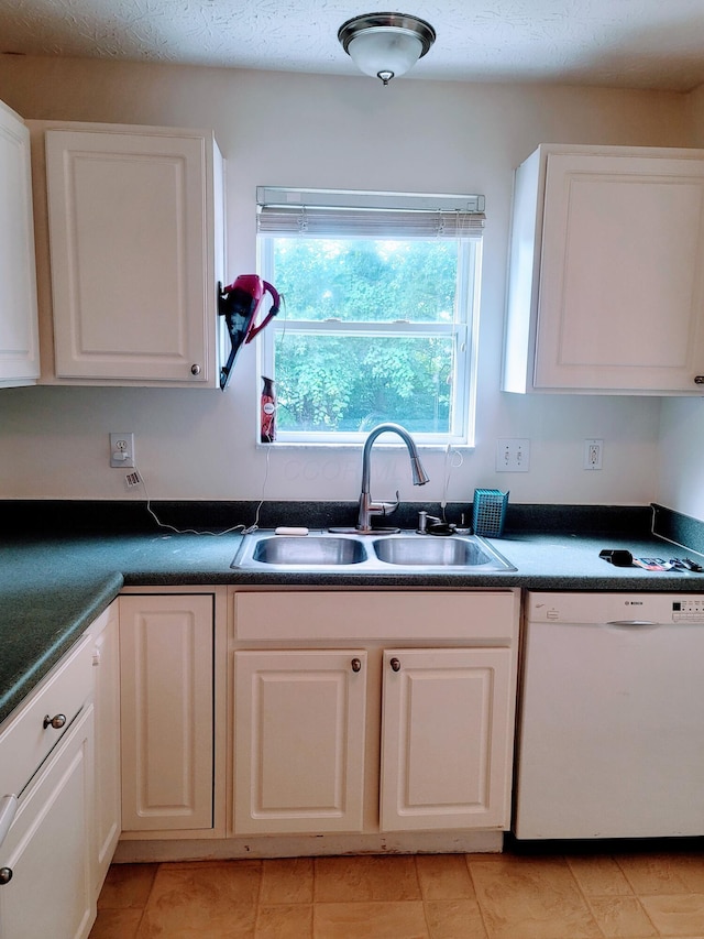 417 Hannifin Dr, Blacklick, OH 43004 - kitchen with white dishwasher, healthy amount of natural light, dark countertops, and light tile patterned floors