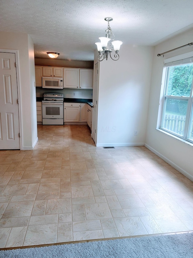417 Hannifin Dr, Blacklick, OH 43004 - kitchen featuring white appliances, a chandelier, dark countertops, a textured ceiling, and hanging light fixtures