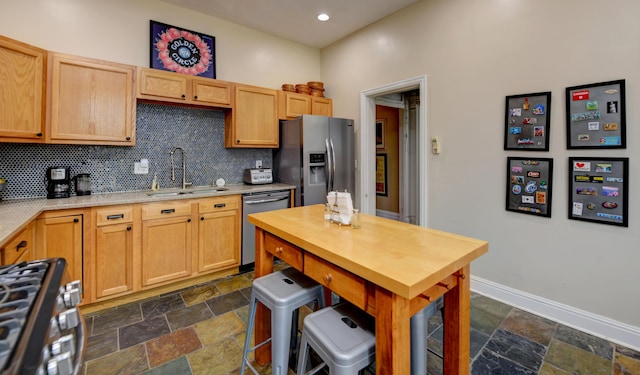 1447 Fair Ave, Columbus, OH 43205 - kitchen featuring stainless steel appliances, stone tile flooring, tasteful backsplash, and recessed lighting