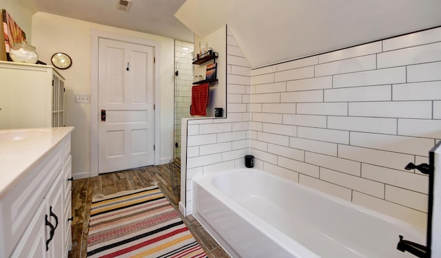 1447 Fair Ave, Columbus, OH 43205 - bathroom with a tub to relax in, wood finished floors, vanity, and a shower