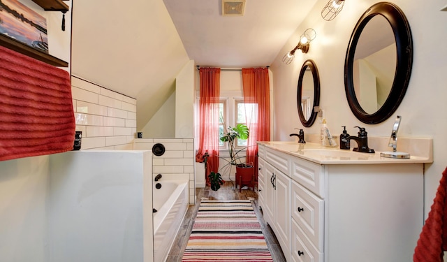 1447 Fair Ave, Columbus, OH 43205 - full bath with double vanity, a garden tub, lofted ceiling, and backsplash