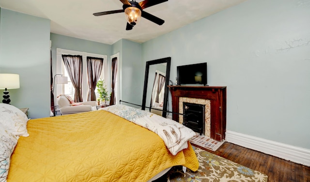 1447 Fair Ave, Columbus, OH 43205 - bedroom featuring wood finished floors, a ceiling fan, and a fireplace with flush hearth