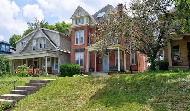 1447 Fair Ave, Columbus, OH 43205 - view of front of property featuring a porch, brick siding, a front yard, and a chimney