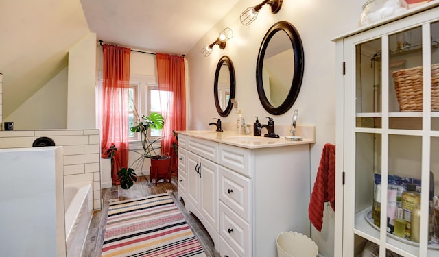 1447 Fair Ave, Columbus, OH 43205 - bathroom with lofted ceiling, double vanity, and a bath