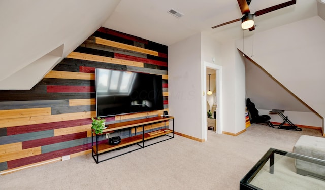 1447 Fair Ave, Columbus, OH 43205 - living area with wooden walls, ceiling fan, and carpet floors