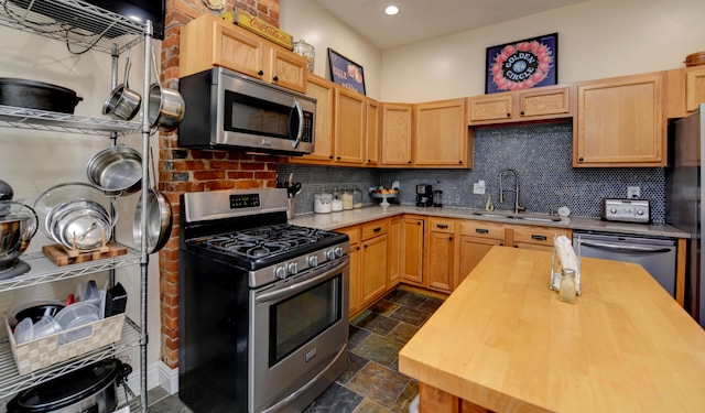 1447 Fair Ave, Columbus, OH 43205 - kitchen with appliances with stainless steel finishes, butcher block counters, backsplash, dark stone finish floors, and recessed lighting