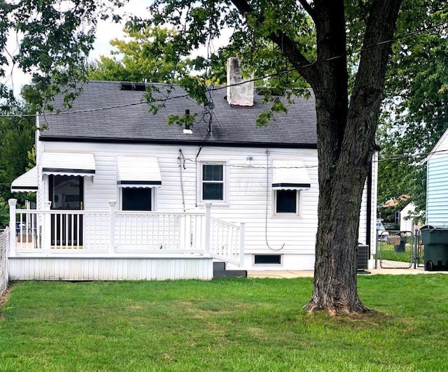 2580 Audubon Rd, Columbus, OH 43211 - back of house featuring a yard, roof with shingles, a chimney, and a wooden deck