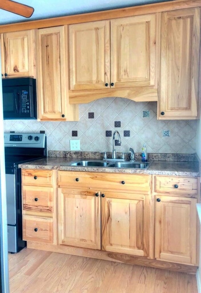 2580 Audubon Rd, Columbus, OH 43211 - kitchen featuring stainless steel electric range oven, black microwave, light brown cabinets, and backsplash