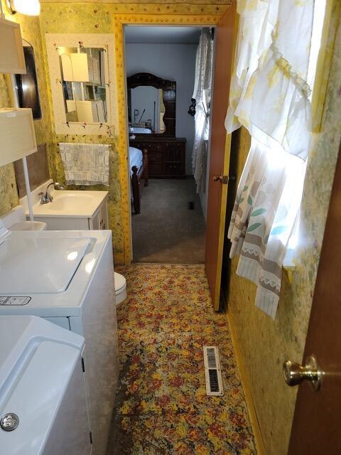 327 Ziegler Ave, Columbus, OH 43207 - bathroom with washing machine and dryer and vanity