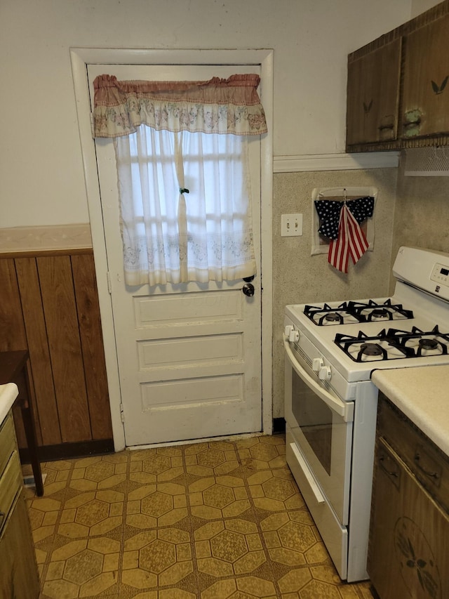 327 Ziegler Ave, Columbus, OH 43207 - kitchen featuring white gas range, light floors, and light countertops