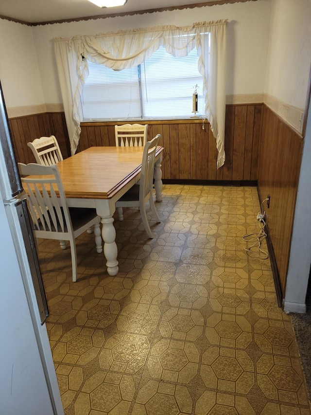 327 Ziegler Ave, Columbus, OH 43207 - dining space with wood walls, a wainscoted wall, and light flooring