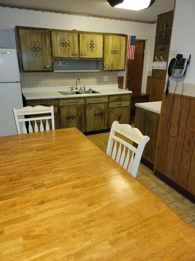327 Ziegler Ave, Columbus, OH 43207 - kitchen with freestanding refrigerator, light countertops, backsplash, and light floors