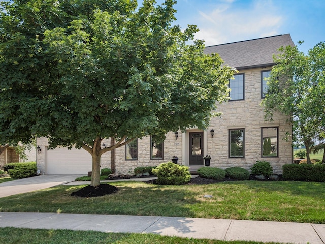 7635 Overland Trl, Delaware, OH 43015 - view of front of home with stone siding, a front lawn, driveway, and a garage