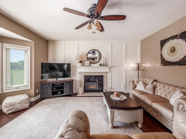 7635 Overland Trl, Delaware, OH 43015 - living area with a ceiling fan, a textured ceiling, wood finished floors, and a tiled fireplace