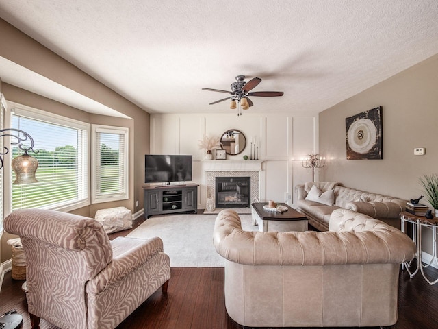 7635 Overland Trl, Delaware, OH 43015 - living room with ceiling fan, a glass covered fireplace, a textured ceiling, and wood finished floors