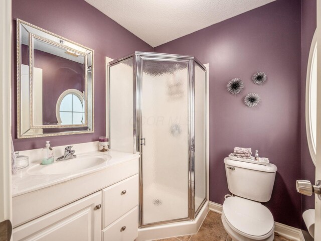 7635 Overland Trl, Delaware, OH 43015 - bathroom featuring a stall shower, vanity, tile patterned flooring, and a textured ceiling
