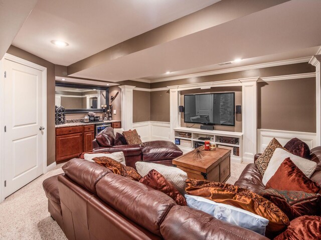7635 Overland Trl, Delaware, OH 43015 - living room featuring bar with sink, decorative columns, light carpet, a decorative wall, and ornamental molding